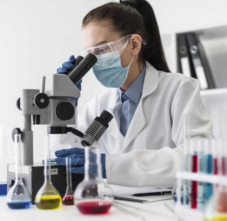 medium-shot-woman-looking-through-microscope